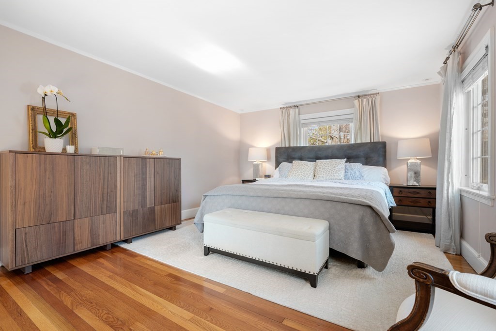 63 Standish Road Milton, MA 02186 - Photo 16 of 38 a bedroom with a bed and cabinets