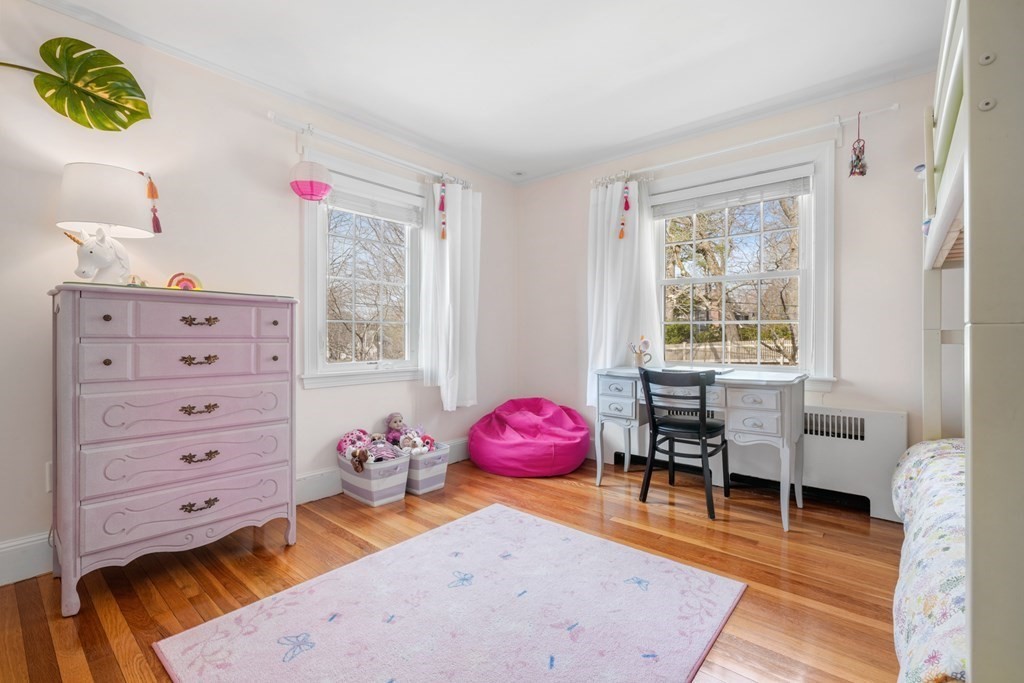 63 Standish Road Milton, MA 02186 - Photo 19 of 38 a bedroom with a bed and wooden floor