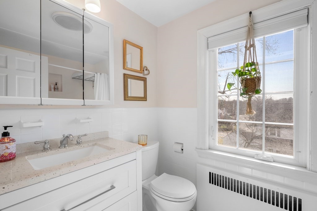 63 Standish Road Milton, MA 02186 - Photo 24 of 38 a bathroom with a granite countertop sink mirror vanity and next to a window