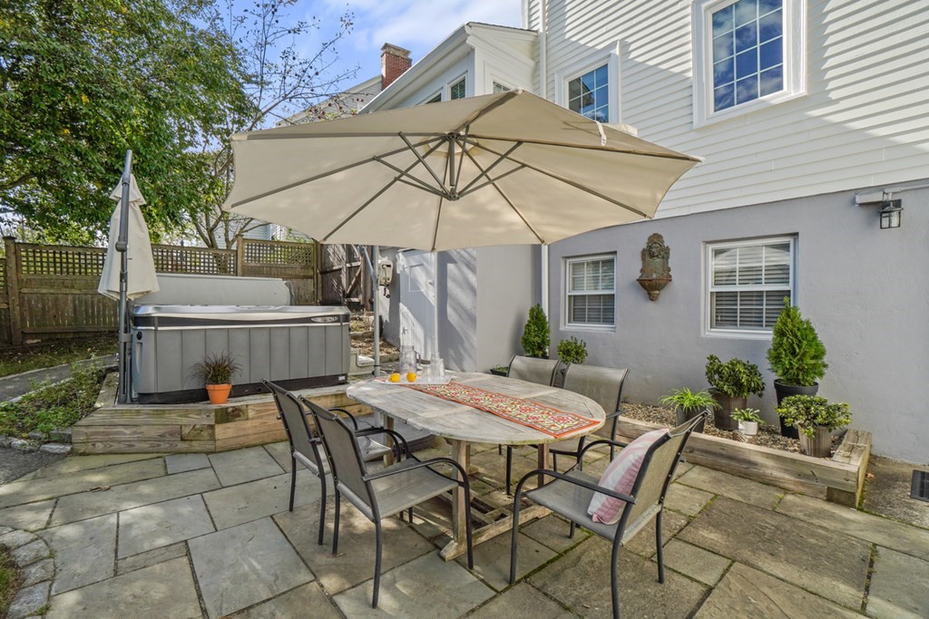 63 Standish Road Milton, MA 02186 - Photo 29 of 38 a view of a patio with table and chairs under an umbrella