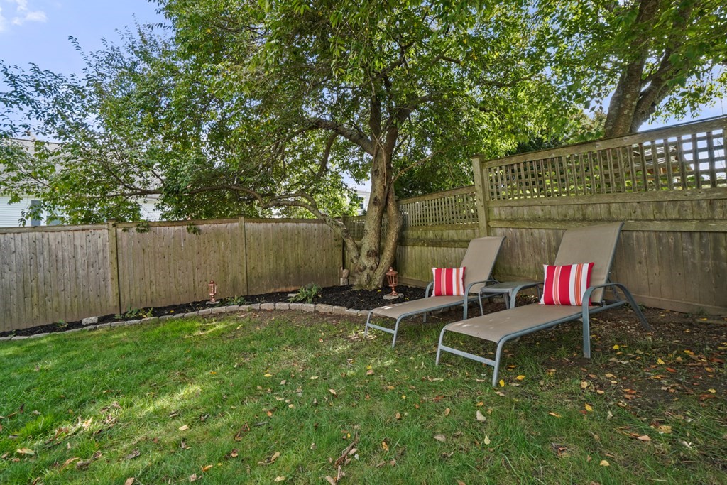 63 Standish Road Milton, MA 02186 - Photo 31 of 38 a backyard of a house with table and chairs