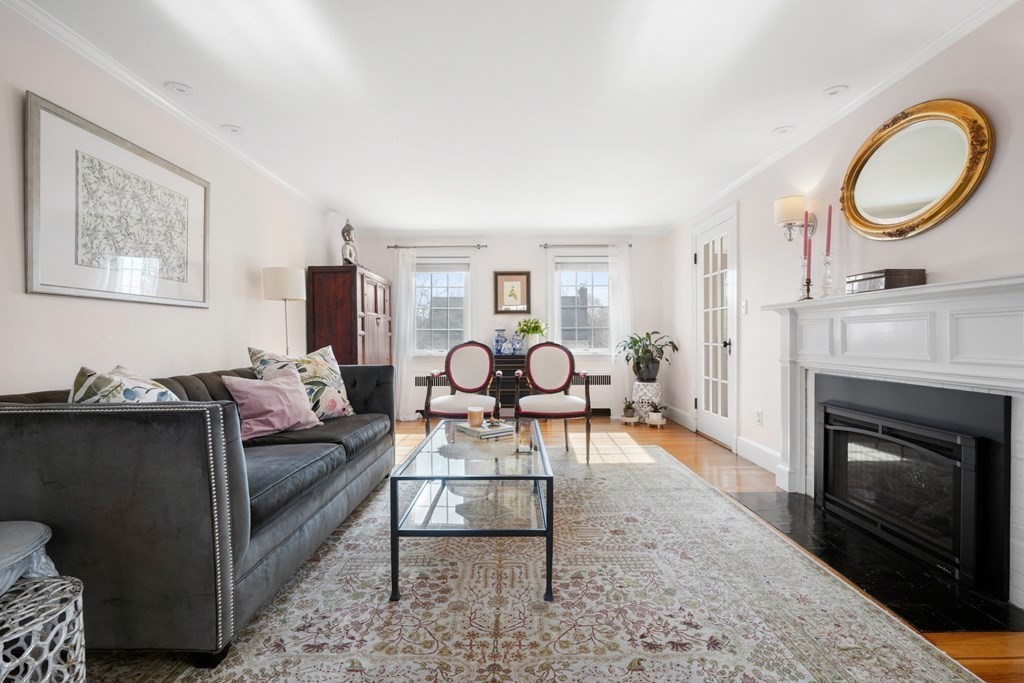 63 Standish Road Milton, MA 02186 - Photo 4 of 38 a living room with furniture a rug potted plant and a fireplace