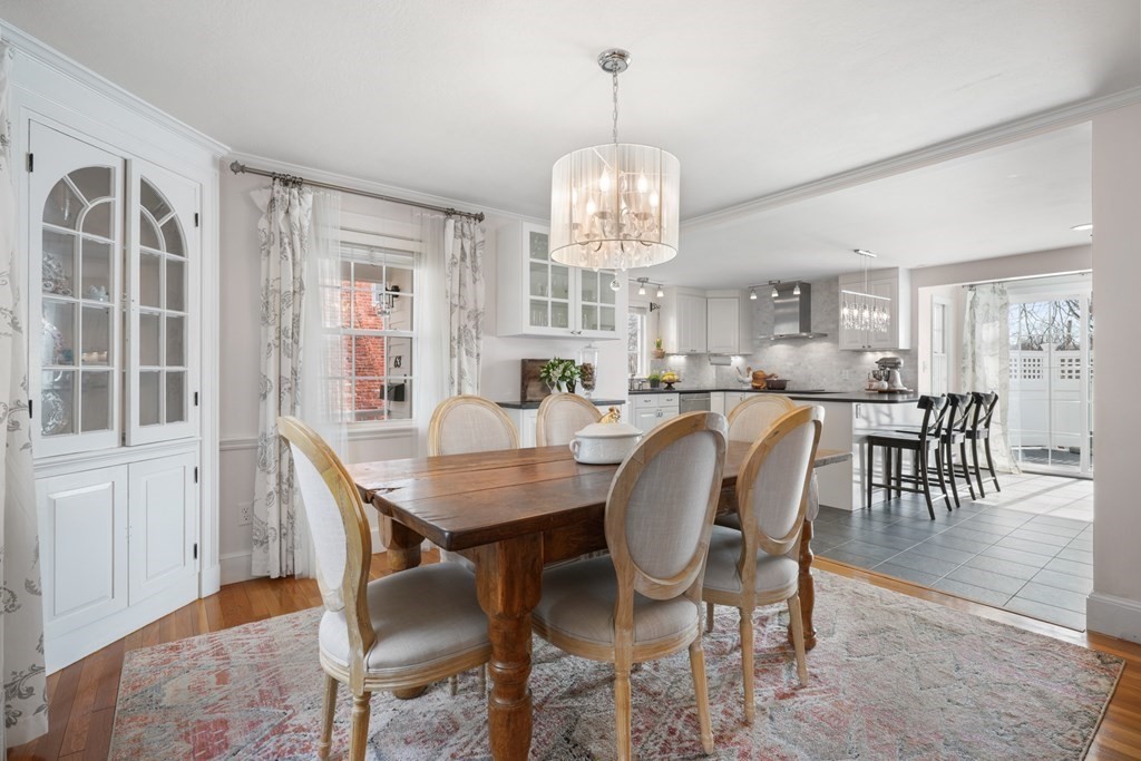 63 Standish Road Milton, MA 02186 - Photo 6 of 38 a view of a dining room with furniture a chandelier and wooden floor