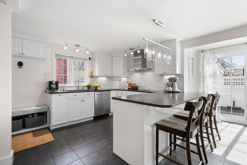63 Standish Road Milton, MA 02186 - Photo 8 of 38 a kitchen with cabinets and chairs