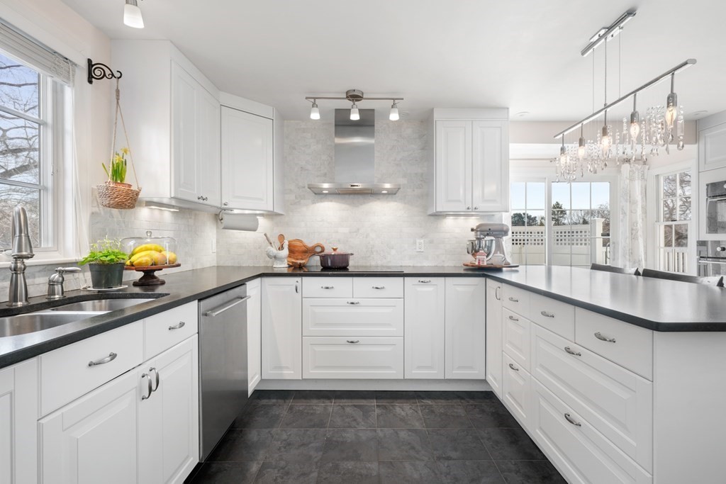 63 Standish Road Milton, MA 02186 - Photo 9 of 38 a kitchen with granite countertop white cabinets white appliances and a sink