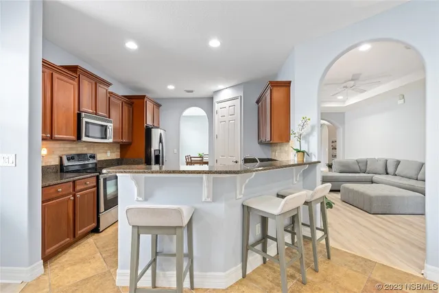 a large kitchen with a table and chairs in it