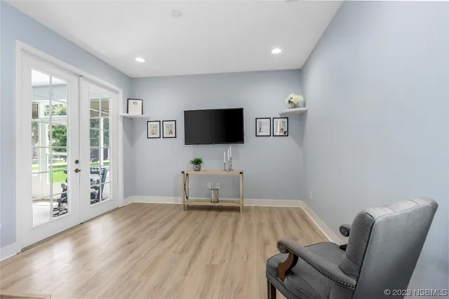 a living room with furniture and a flat screen tv