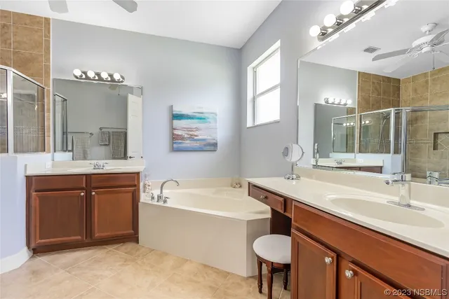 a bathroom with a sink double vanity and a bathtub