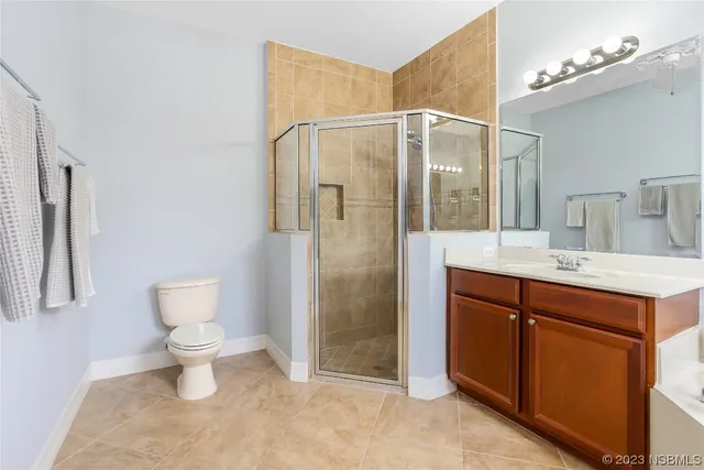a bathroom with a shower sink vanity and toilet