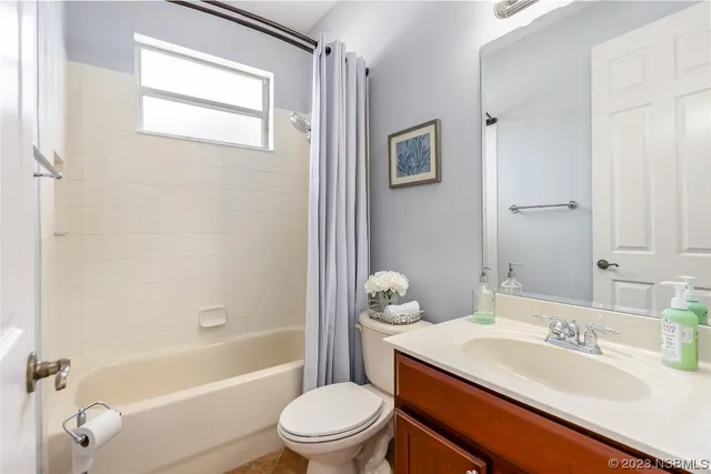 a bathroom with a granite countertop sink toilet a mirror and shower