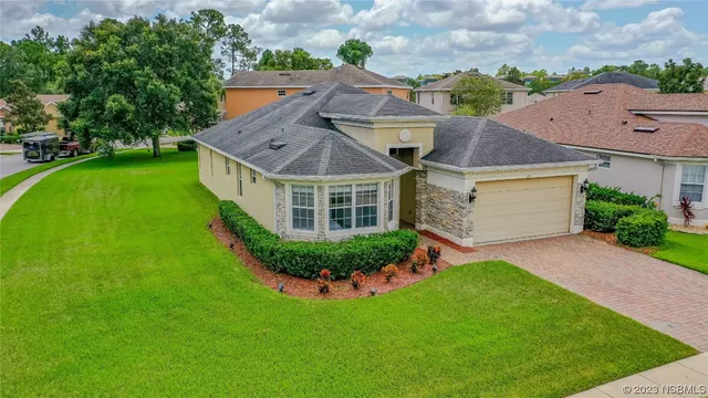 a aerial view of a house with a yard table and chairs