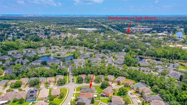 an aerial view of residential houses with outdoor space and swimming pool