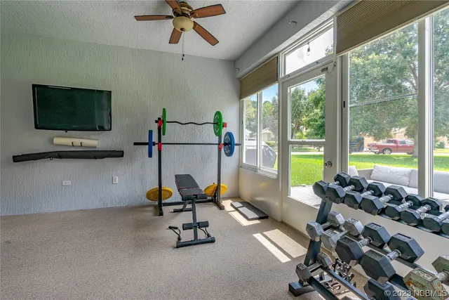 a view of a workspace with furniture and a flat screen tv