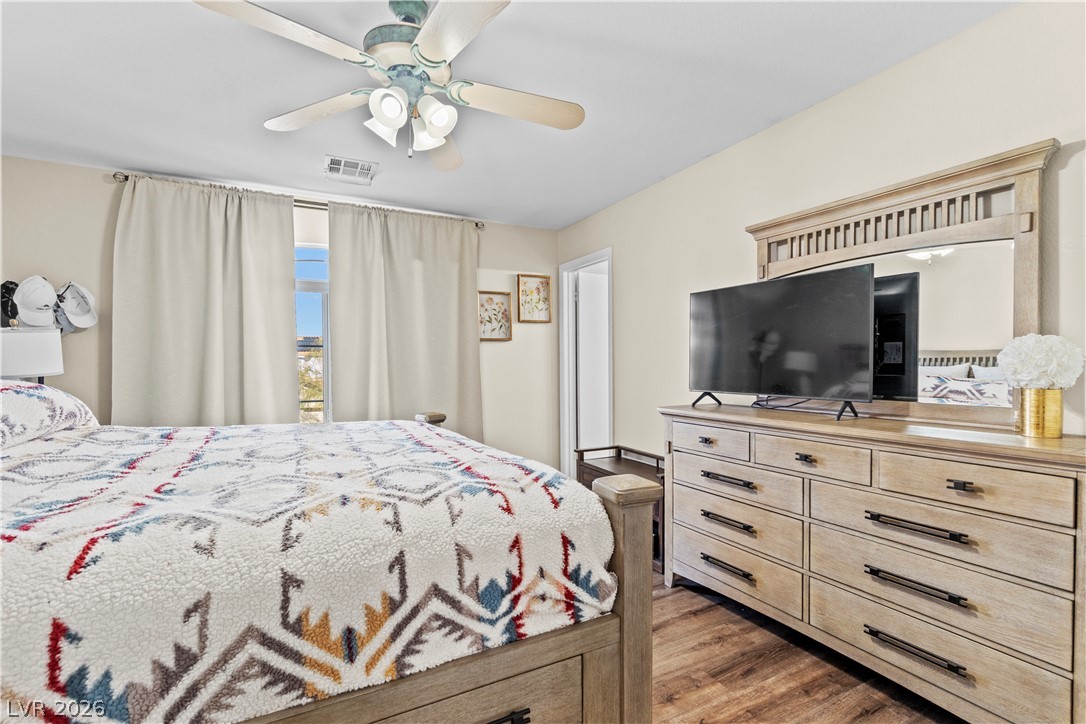 1419 Red Sunset Avenue Henderson, NV 89074 - Photo 20 of 35 Bedroom with dark wood finished floors and a ceiling fan