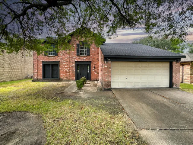a front view of a house with yard and garage