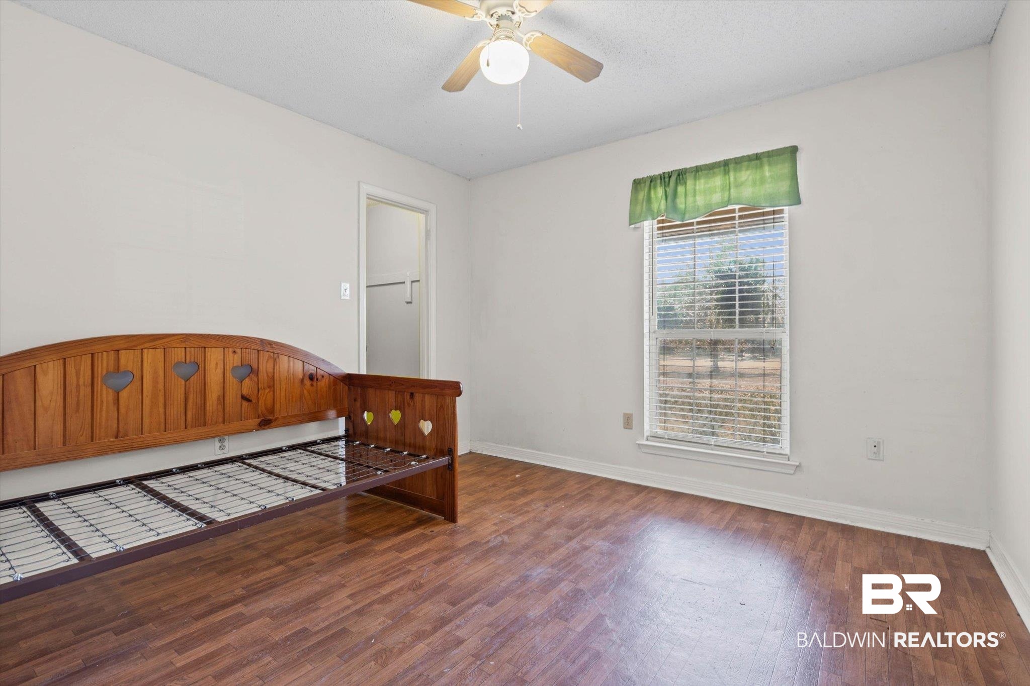 180 Creax Road Axis, AL 36505 - Photo 14 of 35 Unfurnished bedroom featuring wood finished floors, a ceiling fan, and a textured ceiling