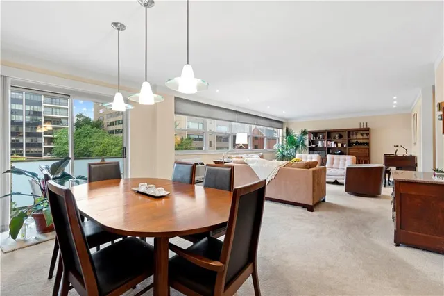 a view of a dining room and livingroom furniture wooden floor and a chandelier
