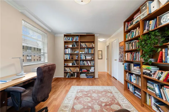 a living room with a book shelf and a book shelf