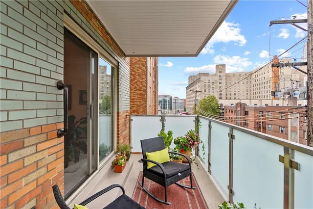 a balcony with table and chairs