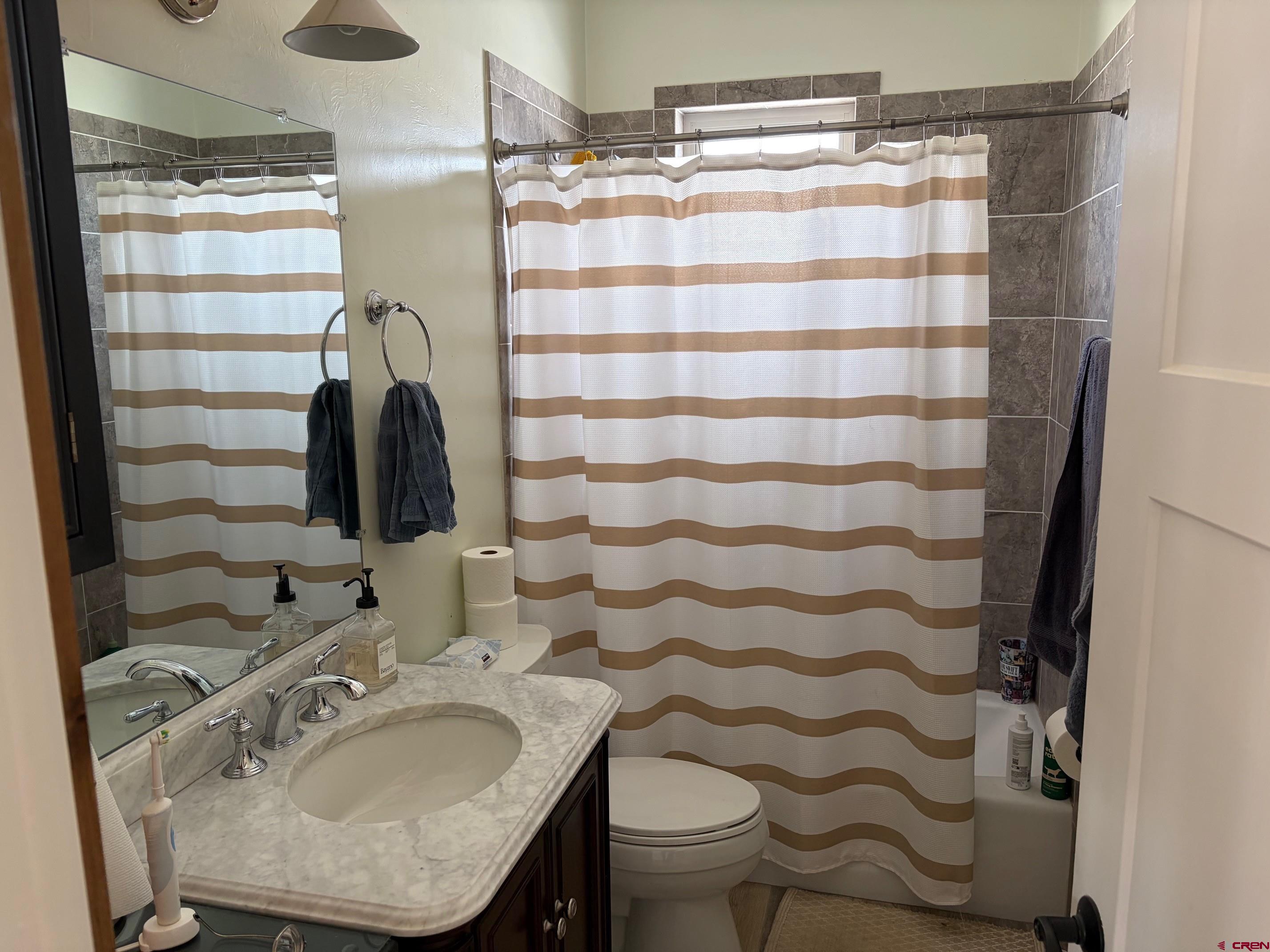 139 South Charlotte Street Ridgway, CO 81432 - Photo 15 of 26 a bathroom with a sink toilet and shower