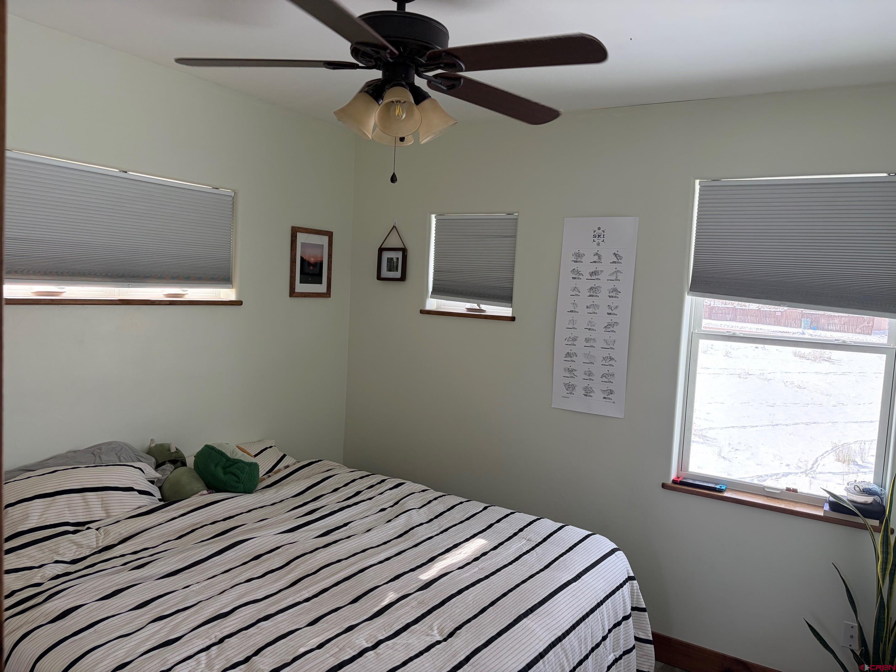 139 South Charlotte Street Ridgway, CO 81432 - Photo 16 of 26 a bedroom with a bed and a window