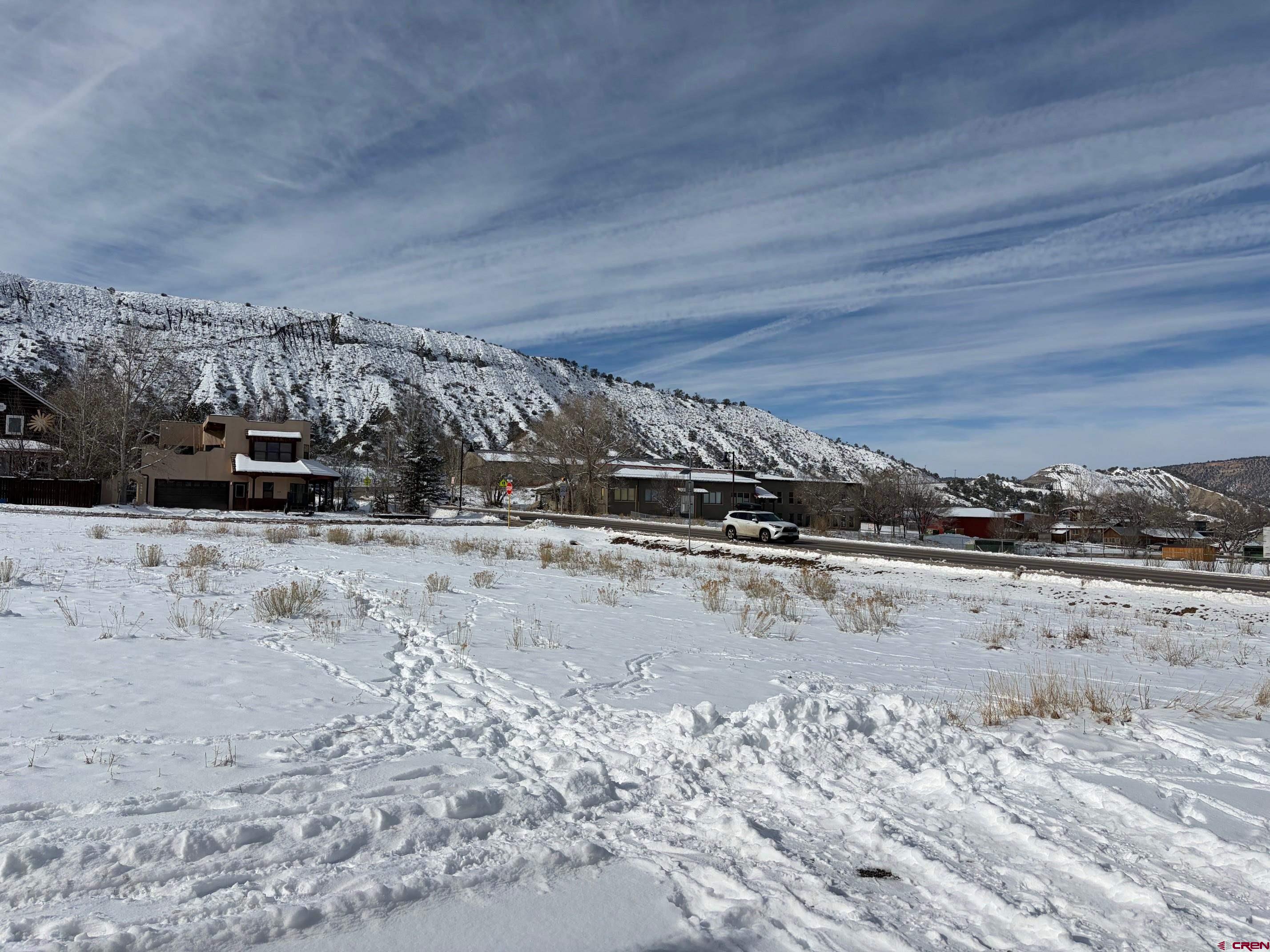 139 South Charlotte Street Ridgway, CO 81432 - Photo 22 of 26 a view of a dry yard covered with snow in the back