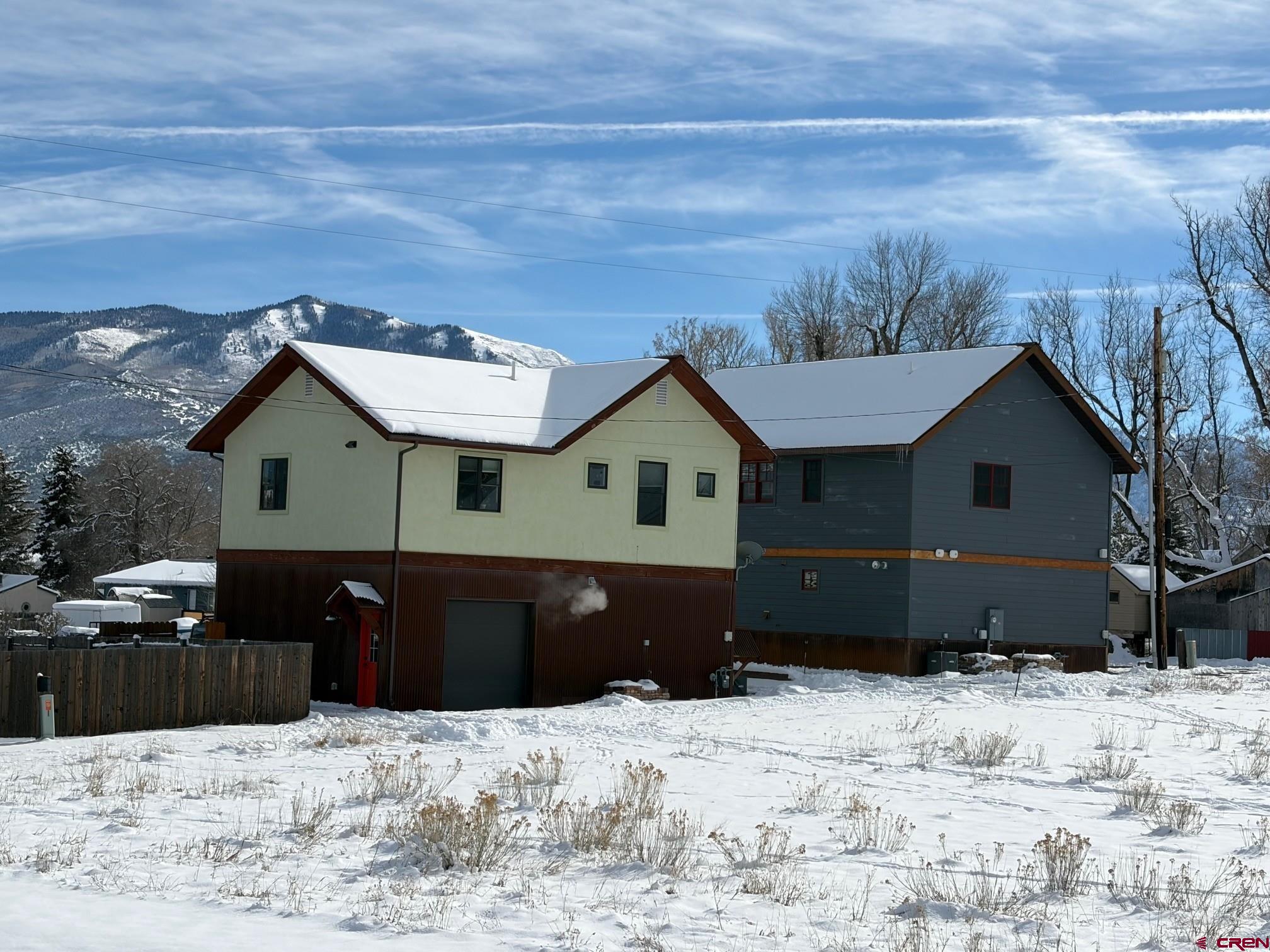 139 South Charlotte Street Ridgway, CO 81432 - Photo 24 of 26 a front view of a house with a yard covered in snow