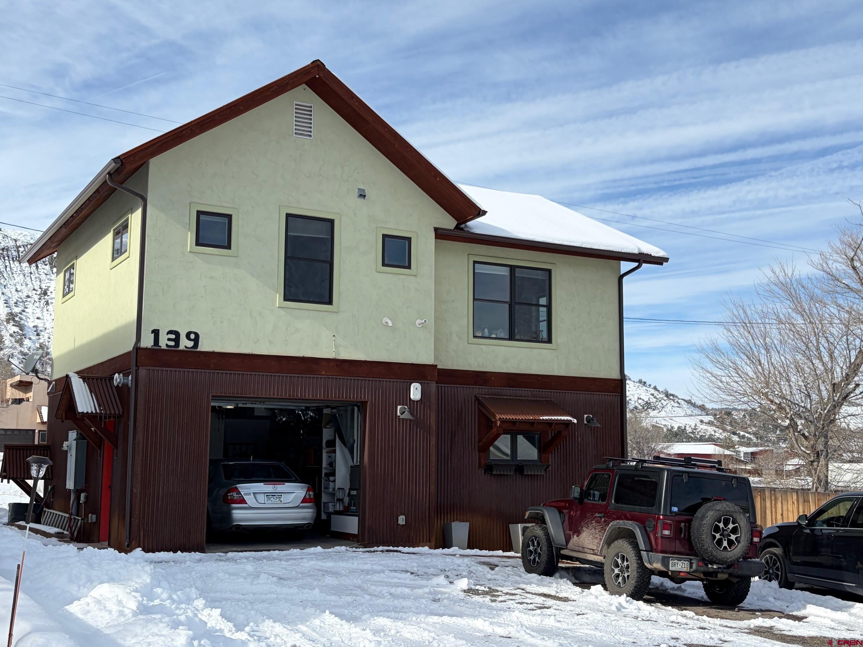 139 South Charlotte Street Ridgway, CO 81432 - Photo 3 of 26 a front view of a house with a garage
