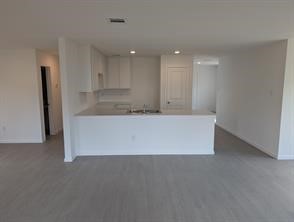 10418 Rocky Trail Beasley, TX 77417 - Photo 3 of 19 a large white kitchen with kitchen island sink and refrigerator