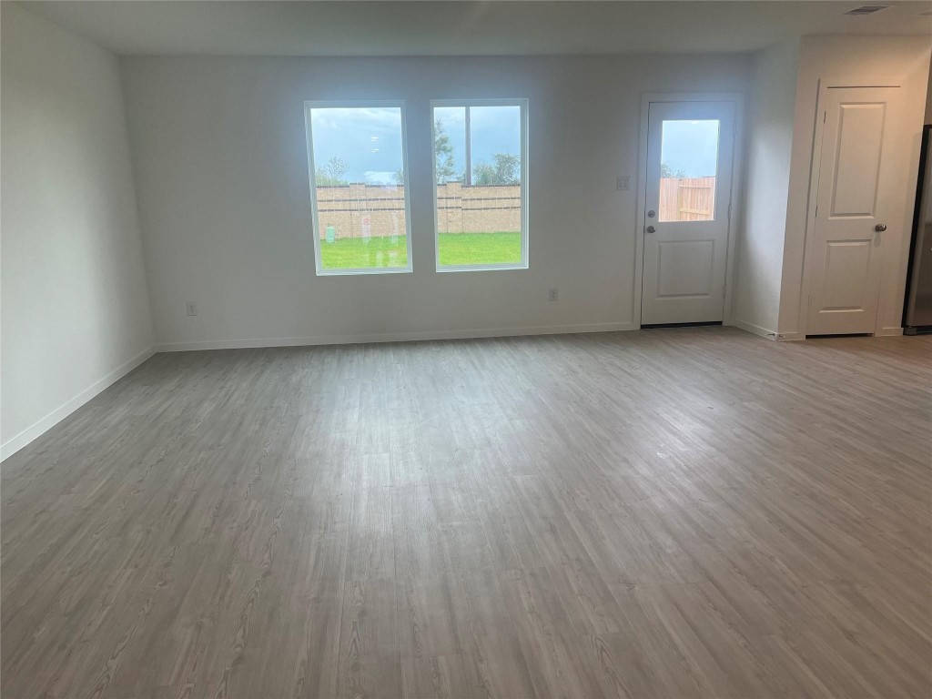 10418 Rocky Trail Beasley, TX 77417 - Photo 6 of 19 an empty room with wooden floor and windows