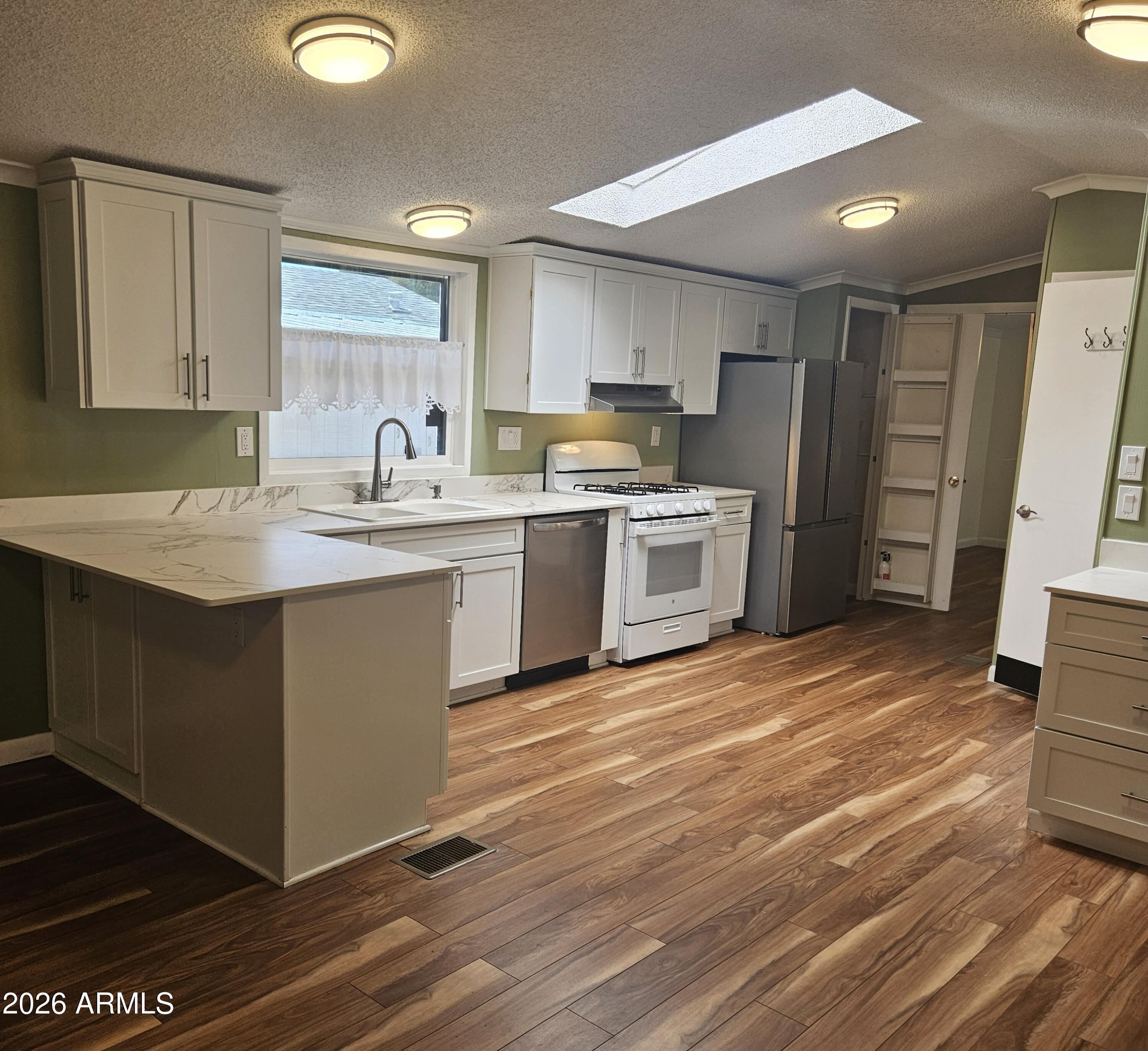 654 Nature Way Sierra Vista, AZ 85635 - Photo 12 of 35 a kitchen with stainless steel appliances granite countertop a sink stove refrigerator and cabinets