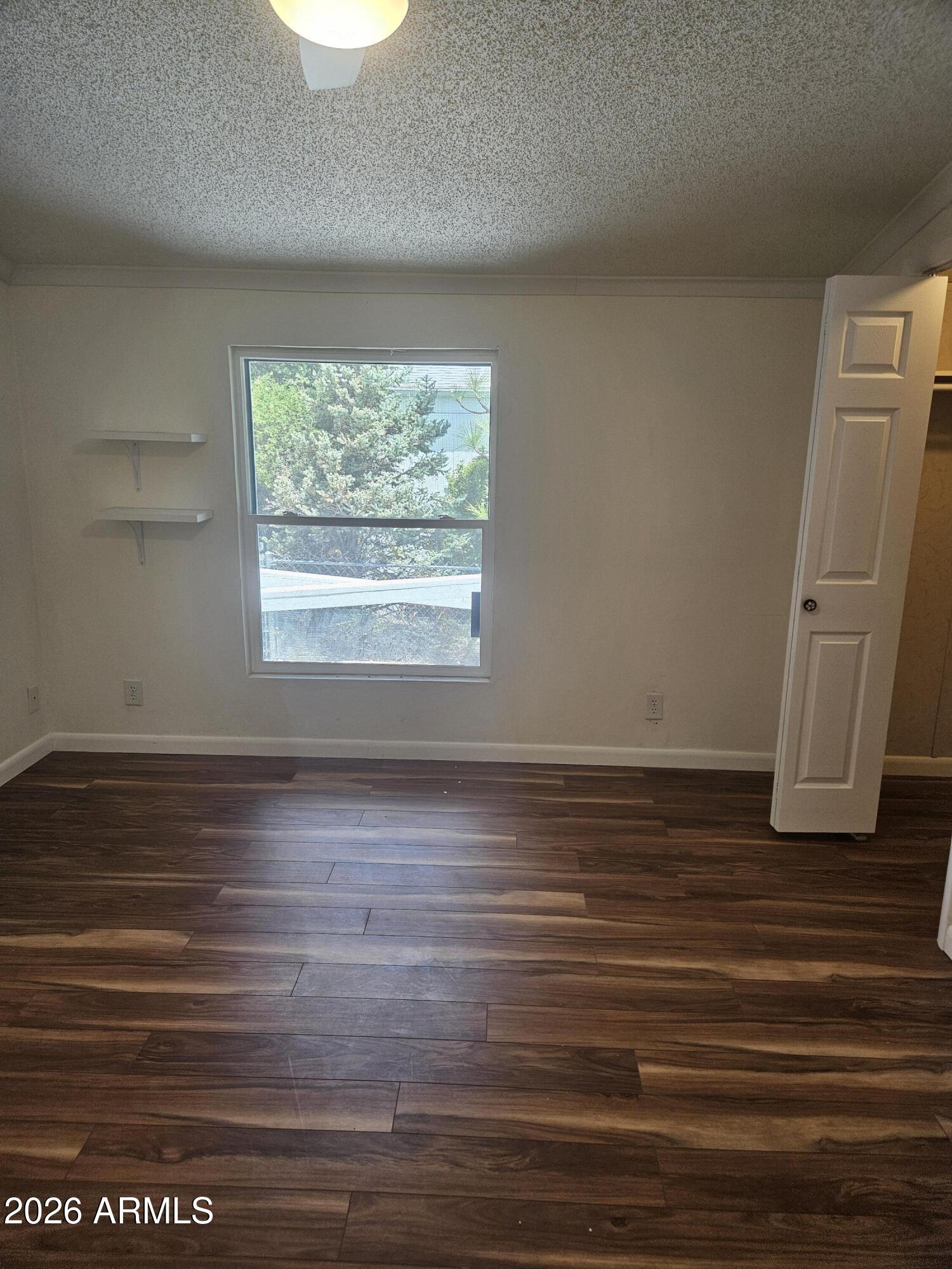 654 Nature Way Sierra Vista, AZ 85635 - Photo 19 of 35 a view of a room with wooden floor and window