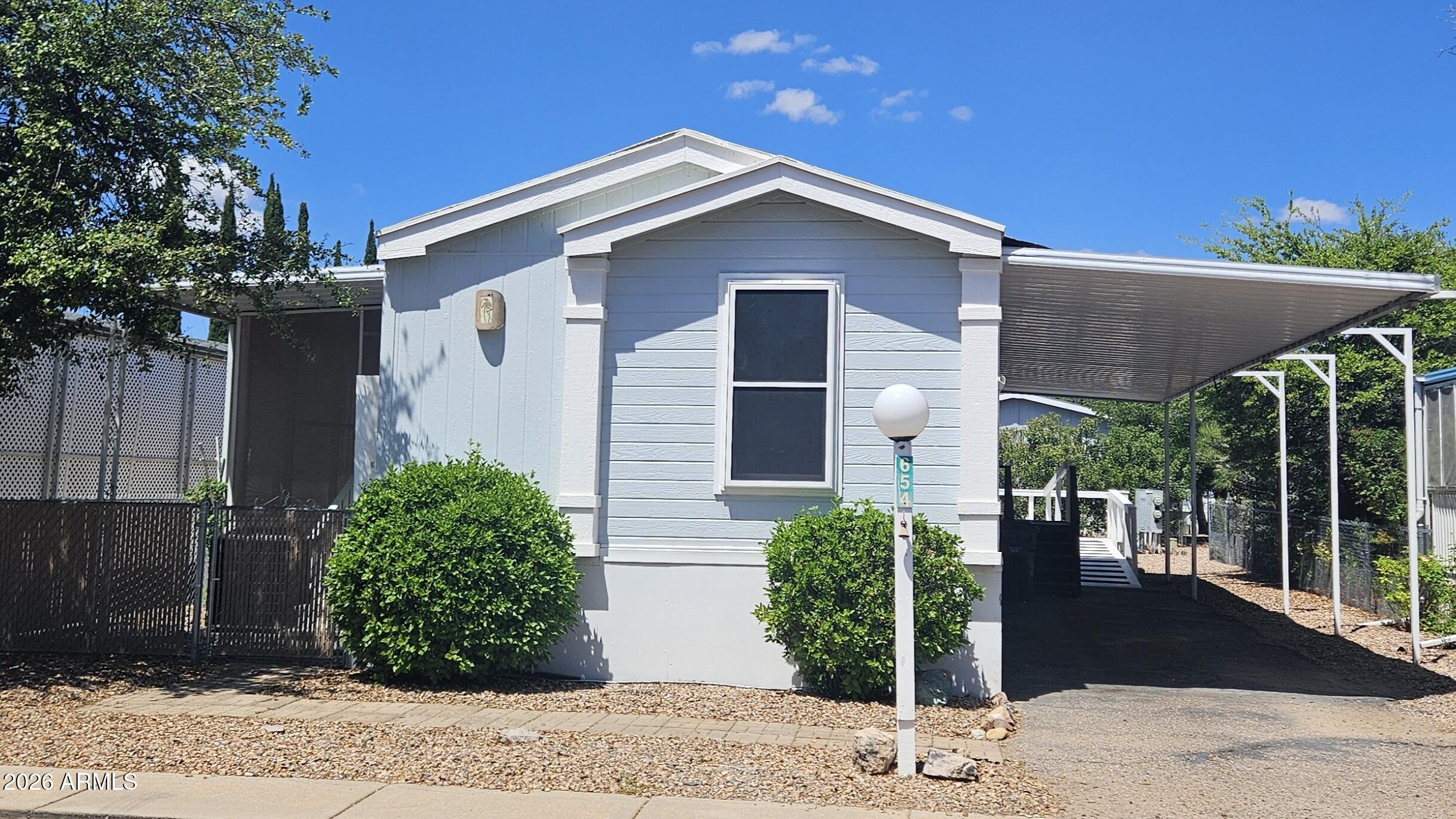 654 Nature Way Sierra Vista, AZ 85635 - Photo 2 of 35 a front view of a house with garden