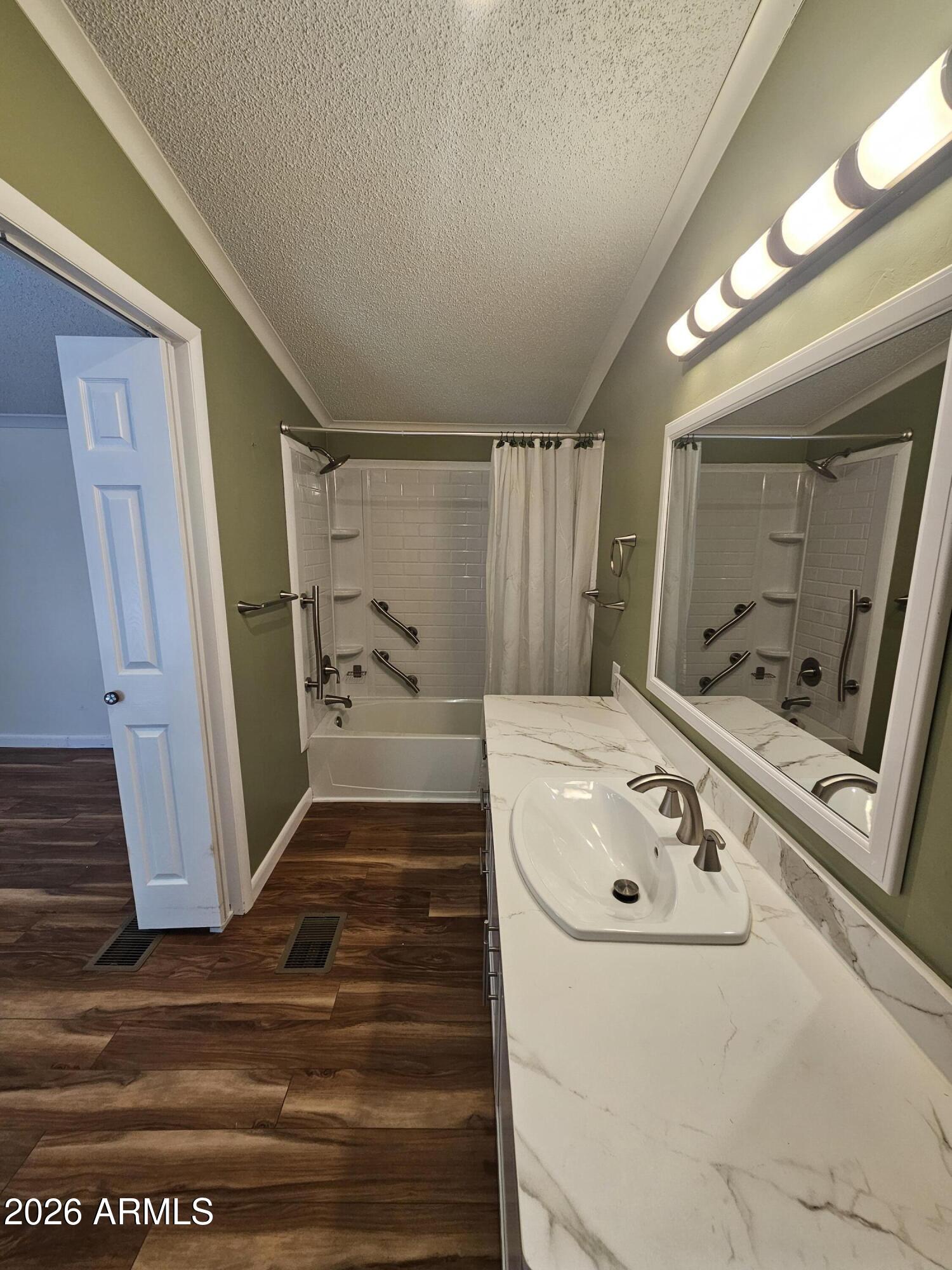654 Nature Way Sierra Vista, AZ 85635 - Photo 22 of 35 a bathroom with a tub sink and mirror