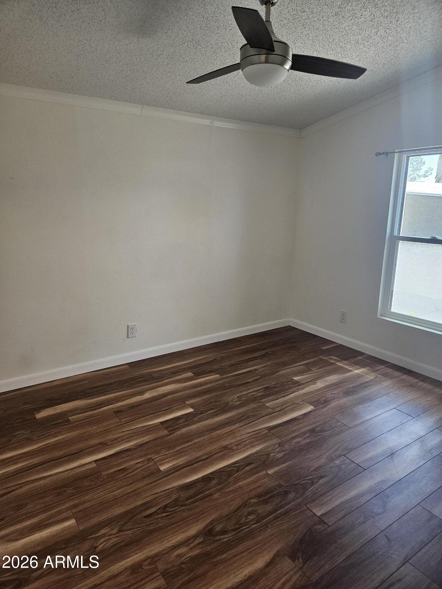654 Nature Way Sierra Vista, AZ 85635 - Photo 23 of 35 an empty room with wooden floor fan and windows