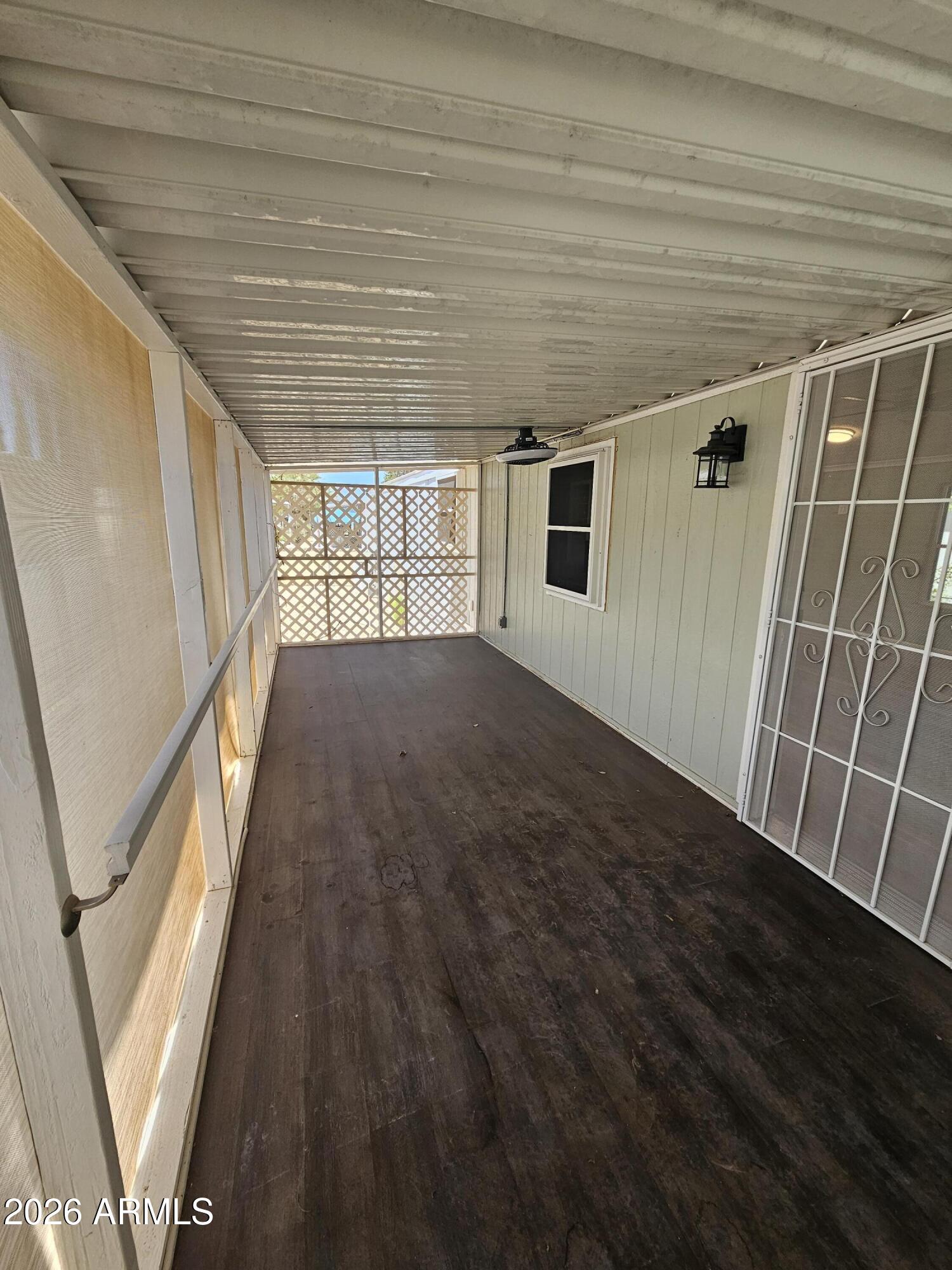 654 Nature Way Sierra Vista, AZ 85635 - Photo 27 of 35 a view of an empty room with wooden floor and a window