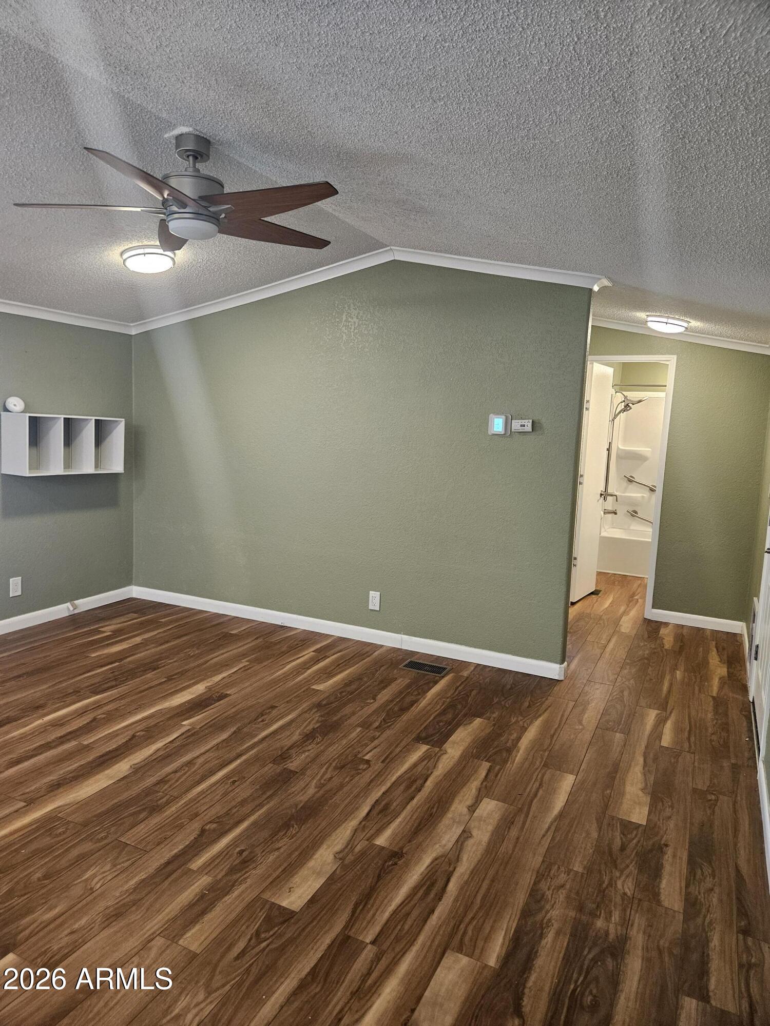 654 Nature Way Sierra Vista, AZ 85635 - Photo 6 of 35 en empty room with wooden floor and fan