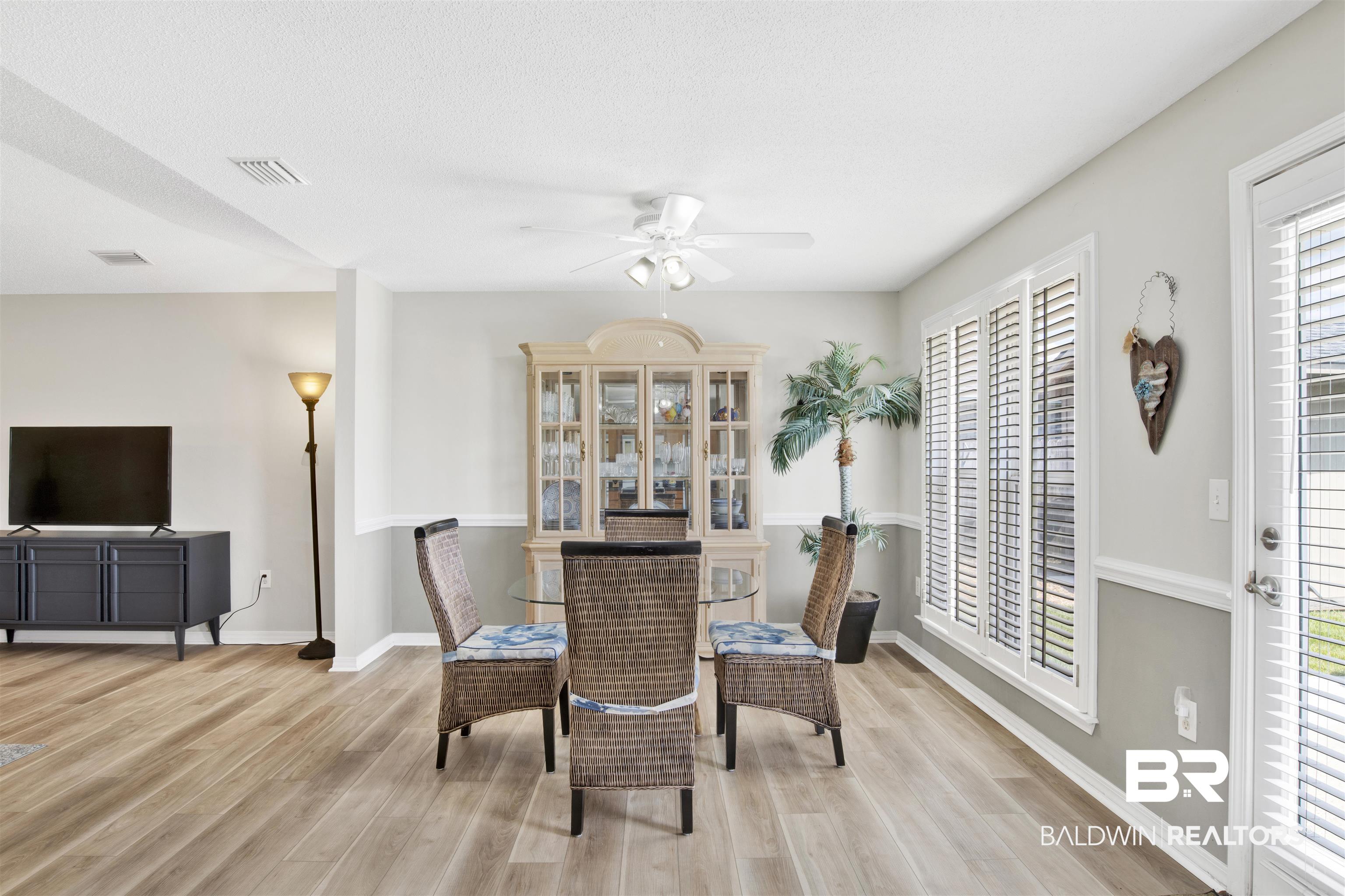 1044 Amazon Drive Foley, AL 36535 - Photo 14 of 29 Dining area featuring a healthy amount of sunlight, light wood-type flooring, and ceiling fan