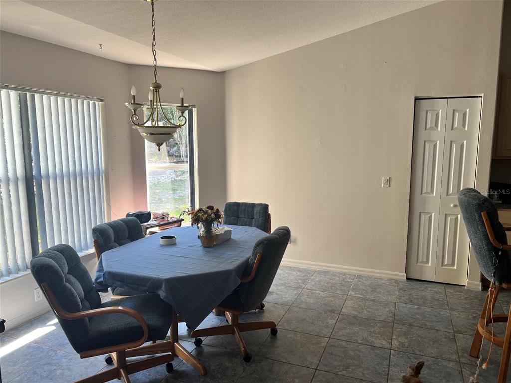 1995 East Newhaven Street Inverness, FL 34453 - Photo 14 of 48 a view of a dining room with furniture window and outside view