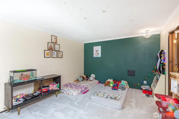 a bedroom with baby toys and a flat screen tv