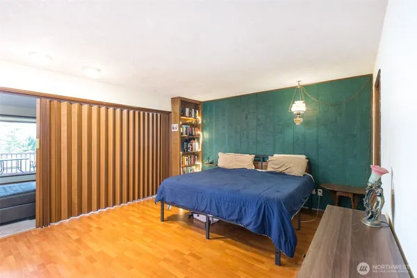 a bedroom with a bed and a night stand