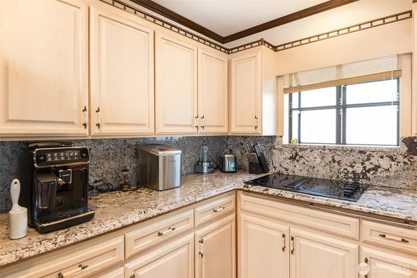 a kitchen with stainless steel appliances granite countertop a sink and a granite counter tops