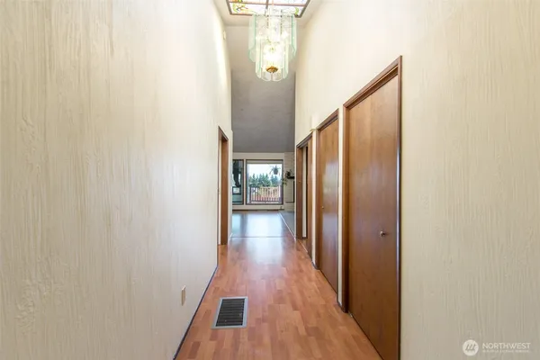 a view of a hallway with wooden floor