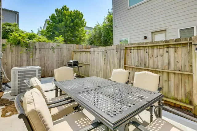 a view of a patio with a table and chairs