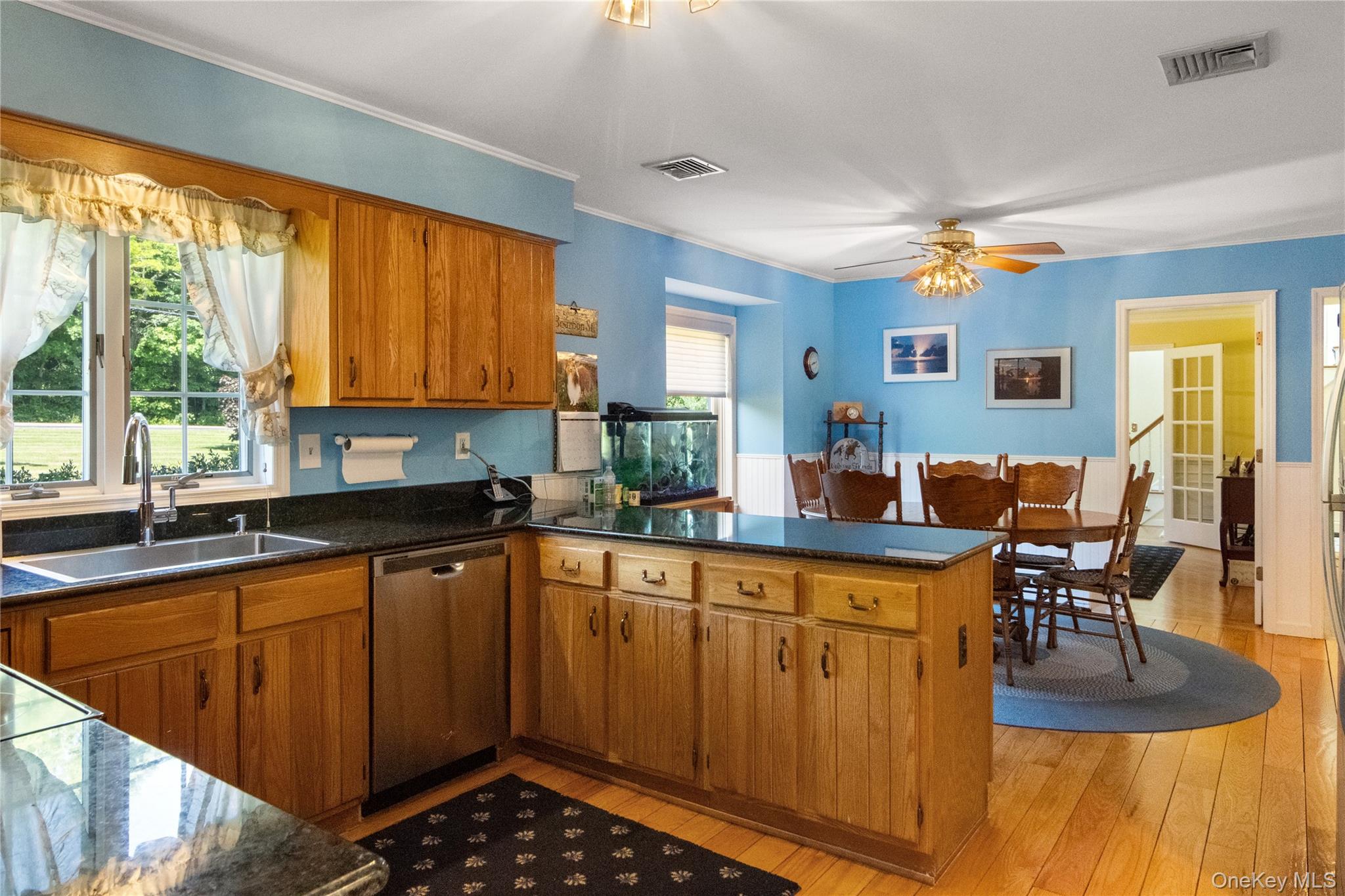 214 West Mombasha Road Monroe, NY 10950 - Photo 13 of 43 a kitchen with stainless steel appliances kitchen island granite countertop a table chairs and a sink