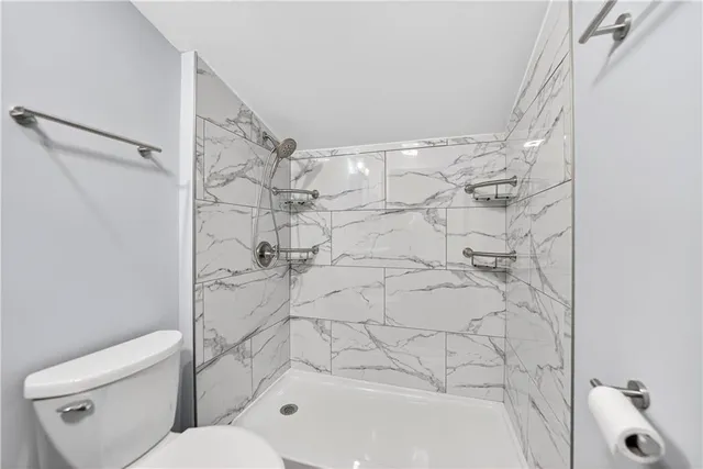 a bathroom with a toilet and a bathtub