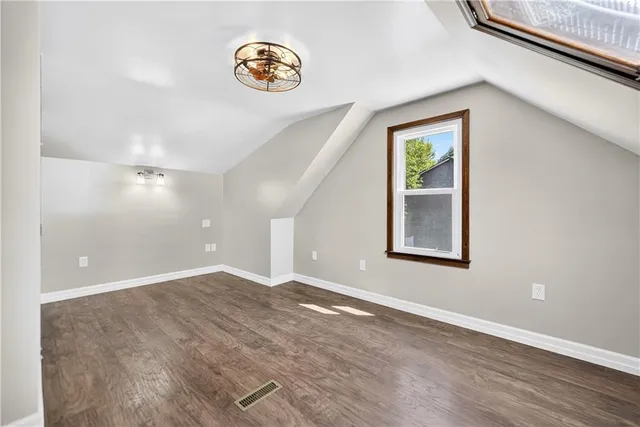 an empty room with windows and entrance