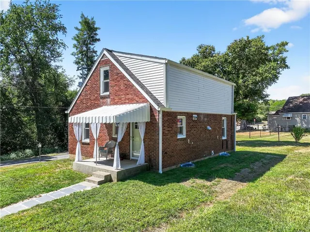 a view of a house with yard and a garden