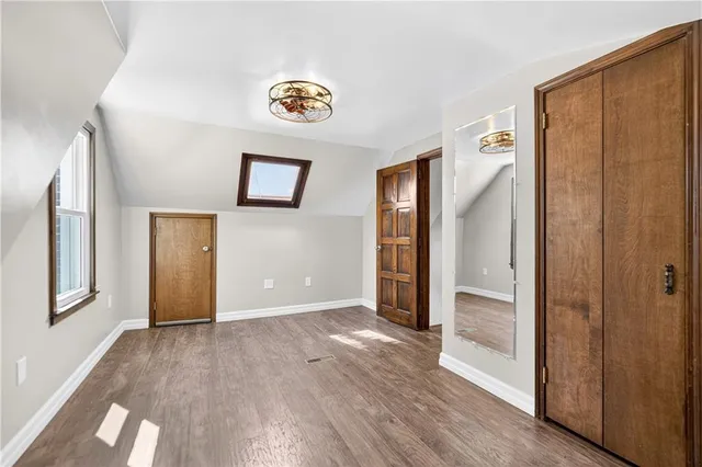 a view of an empty room and wooden floor