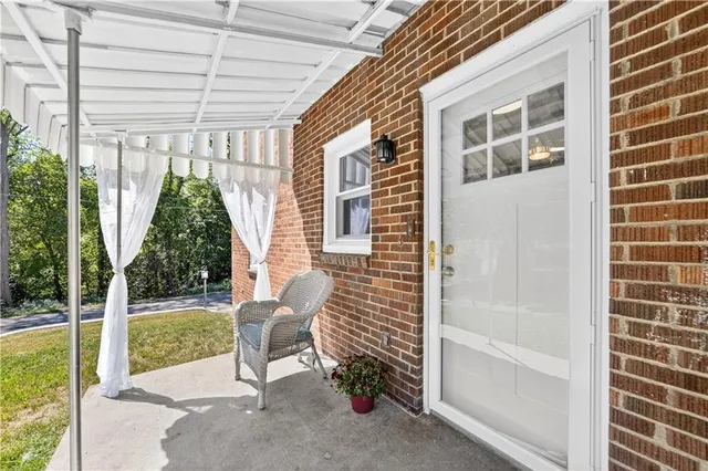 a view of a chair and table in backyard of the house